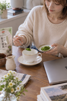 Scooping green tea powder into a teacup