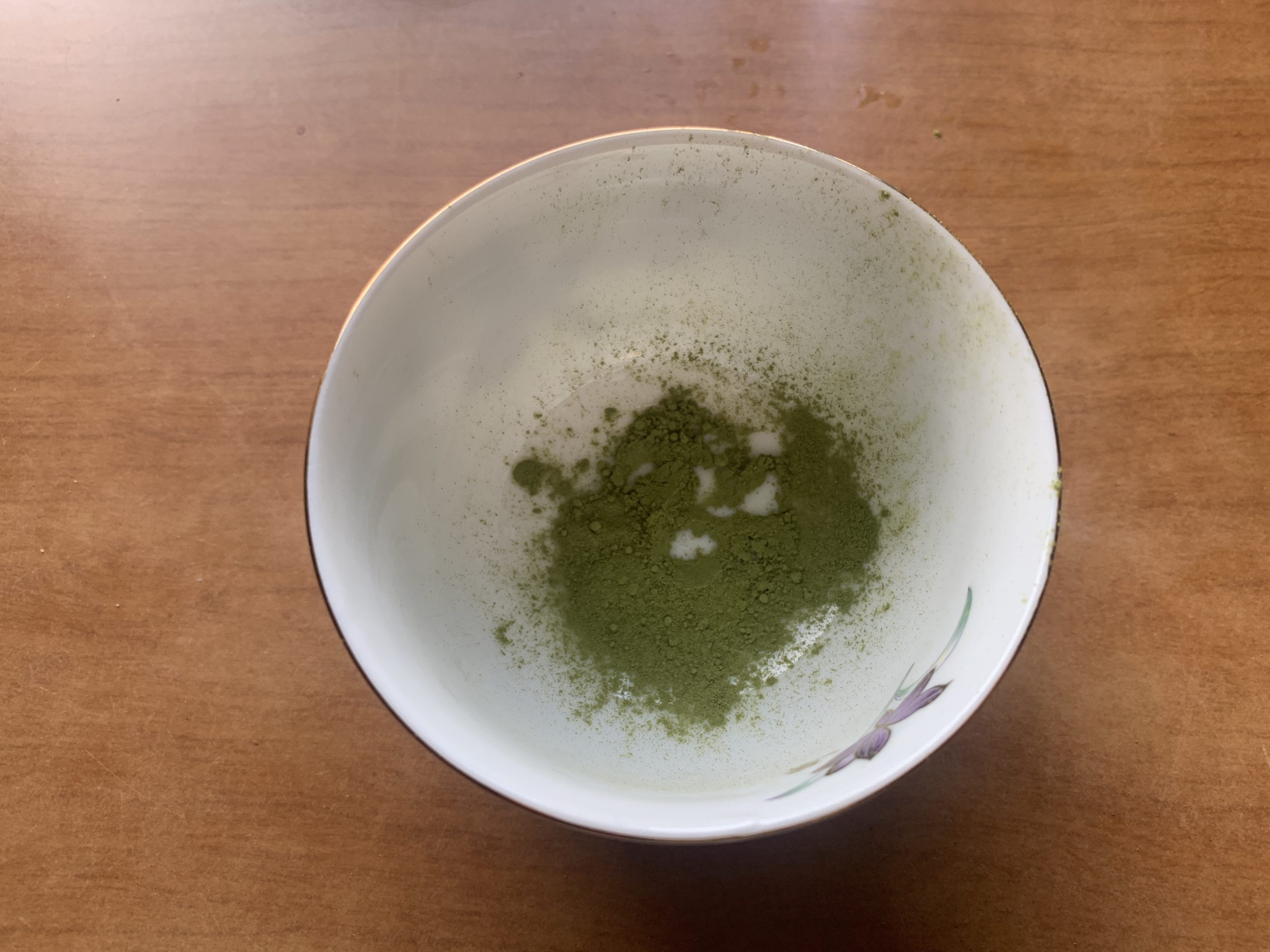Fine matcha powder placed inside a ceramic teacup