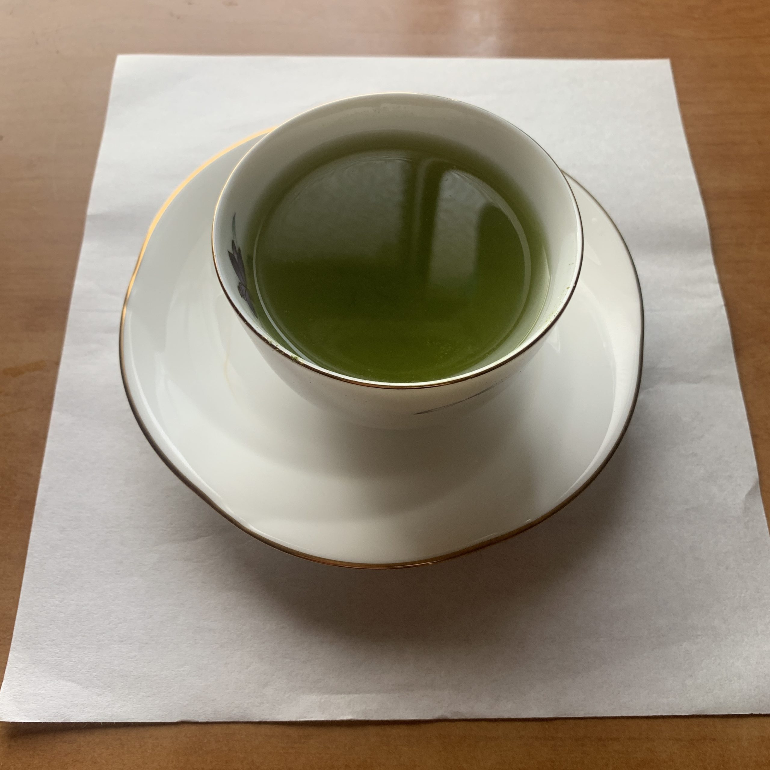 A freshly prepared cup of smooth matcha presented elegantly on a saucer